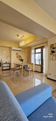 a living room with a blue couch and a table at Serenity by Zen Residences at The Radiance Manila Bay in Manila