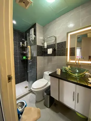 a bathroom with a toilet and a sink and a mirror at Casa Maria in Manila