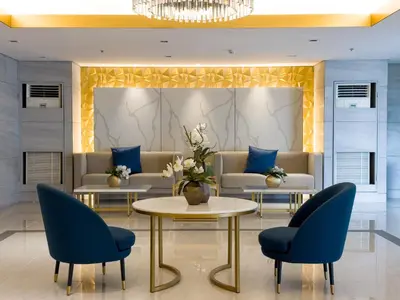 a lobby with couches and a table and chairs at GemstoneBR in SMDC Fame Residences in Manila