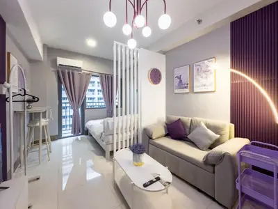 a living room with a couch and a table at GemstoneBR in SMDC Fame Residences in Manila