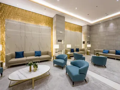 a lobby with couches and chairs and a table at GemstoneBR in SMDC Fame Residences in Manila