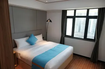 a bedroom with a large bed with blue pillows at Golden Seagulls Hotel in Manila