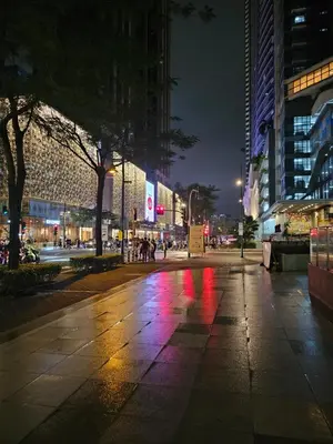 a city street at night with red and purple lights at One Uptown Executive 2 bedroom, with balcony, washer & Netflix in Manila