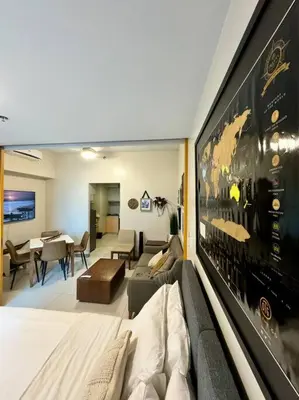 a living room with a couch and a table at BGC 1BR unit linked to Uptown Mall with own parking in Manila