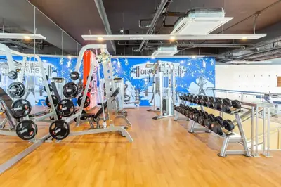 a gym with a bunch of treadmills and machines at Tree of Life Penthouse 3BR w Gym Pool Sauna More in Manila
