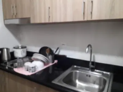 a kitchen counter top with a sink and a sink at Comfy 19 shore2 Residence Free parking, Near Airport, IKEA, MOA, Pasay City in Manila