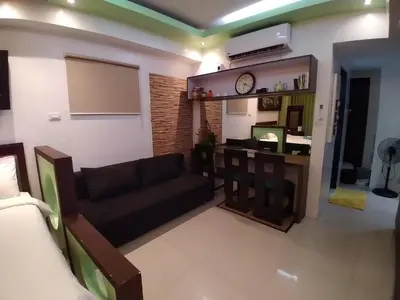 a living room with a couch and a table at Executive Studio Apartment in BGC in Manila