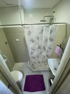 a small bathroom with a toilet and a sink at Shore2 Condo 1BR Balcony, Wifi, Pool, MOA, Airport in Manila