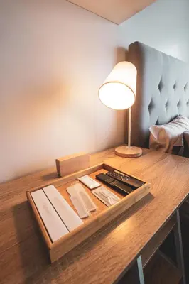 a table with a lamp and books on it at Modern Living 3 Makati in Manila