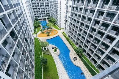 an aerial view of a pool between two buildings at Modern Living 4 MOA Pasay in Manila