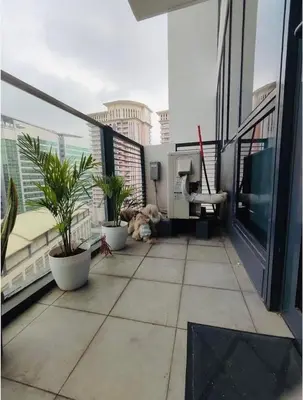 a dog laying on a balcony of a building at BGC McKinley Taguig 1BR with Balcony near Venice Grand Canal mall in Manila