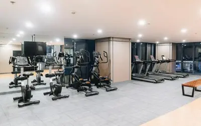 a gym with several treadmills and cardio equipment at BGC McKinley Taguig 1BR with Balcony near Venice Grand Canal mall in Manila