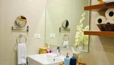a bathroom with a sink and a mirror at BGC McKinley Taguig 1BR with Balcony near Venice Grand Canal mall in Manila