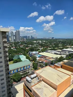 a view of a city from a building at Cozy apartment near Greenbelt Makati City in Manila