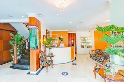 a lobby of a hotel with palm trees at Townhouse OAK Makati Manila Near PNR Pasay Evangelista formerly VIP Suites in Manila