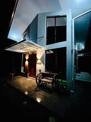 a building with a bike parked outside of it at night at Tagaytay's Cozy Loft-type Forest House and Camp in Silang