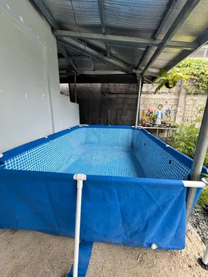 a blue ping pong table under a roof at Tinyhaven Transient Cabuyao in Cabuyao