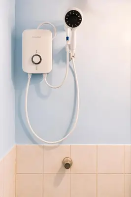 a shower head in the corner of a bathroom at Tinyhaven Transient Cabuyao in Cabuyao