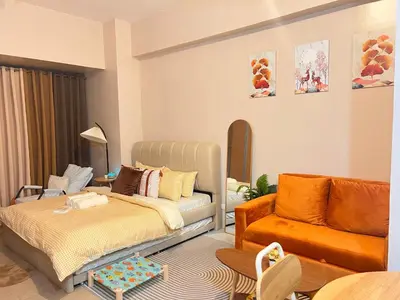 a living room with a bed and a couch at Cozy Condo at Eighty One Newport Blvd across NAIA Terminal 3 in Manila