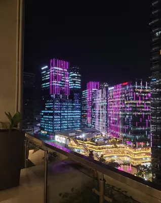 a view of a city lit up at night at Staycations Up Above 13 at BGC in Manila