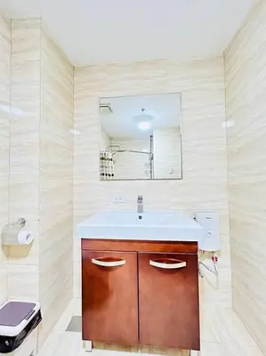 a bathroom with a sink and a mirror at Budget Family Room at Ace Suites by the Famous Indoor Water Spa in Manila