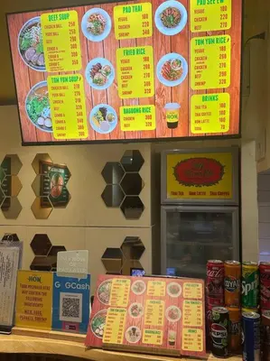 a fast food restaurant with yellow menus on the wall at Sea Residences by Richnells in Manila