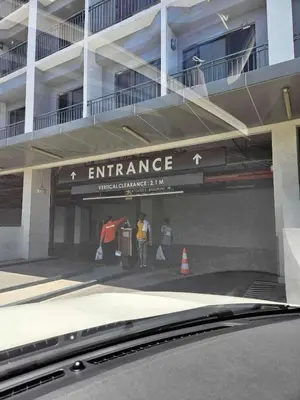 two people standing under an entrance to a building at Nordic Style - 2BR Shore 2 Residences Tower 2 in Manila