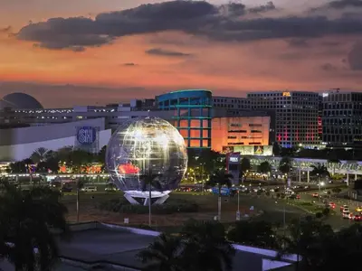 a large disco ball in a city at night at Mall of Asia Sea Residences Staycation Pasay City in Manila