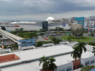 a view of a city with a large building at Mall of Asia Sea Residences Staycation Pasay City in Manila