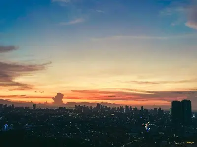 a view of a city at sunset at Condo unit in Manda near Edsa, Shangrila, Megamall in Manila