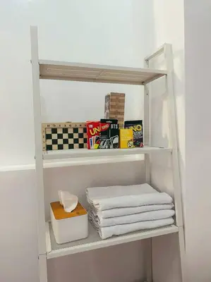 a white shelf with towels and a box on it at Condo unit in Manda near Edsa, Shangrila, Megamall in Manila