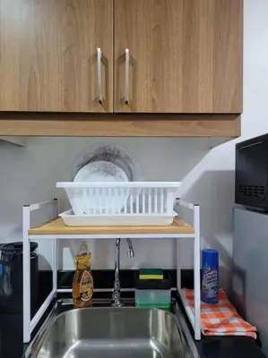 a kitchen sink with a dish rack above it at Jireh's Staycation in Makati in Manila