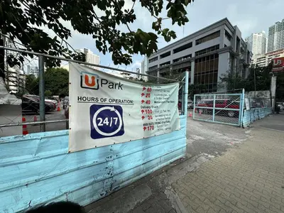 a us park sign on a building in a city at High Rise Condo with Balcony, Pool, Grand Lobby, and Sky Garden 22F in Manila