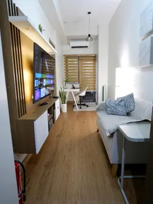 a living room with a couch and a television at Casa Bella at S Residence, Near SM Mall of Asia in Manila