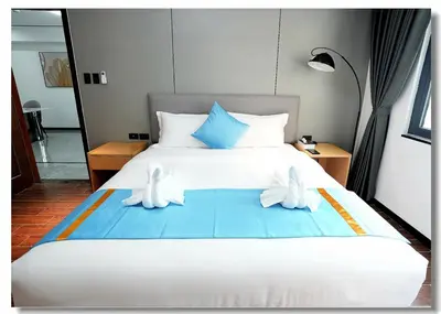 a bedroom with a bed with white shoes on it at Golden Seagulls Hotel in Manila