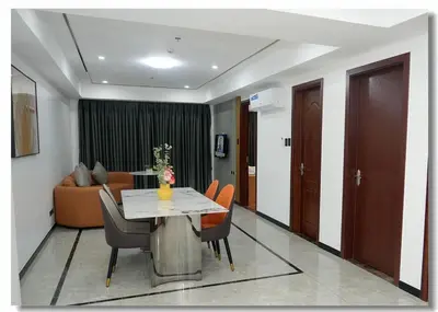 a living room with a table and chairs and a couch at Golden Seagulls Hotel in Manila