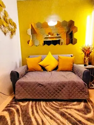 a couch with yellow pillows in a living room at Fame Residence Tower 1 Cozy Hotel Style 1 Bedroom with Balcony pool View in Manila