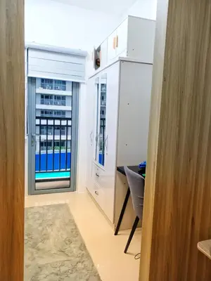 a room with a window with a view of a building at Fame Residence Tower 1 Cozy Hotel Style 1 Bedroom with Balcony pool View in Manila