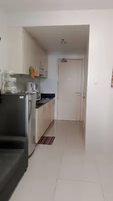 a small kitchen with a couch in a room at Eriel condotel in Manila