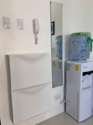 a kitchen with a refrigerator and a phone on a wall at Perfect accommodation for you in Levels Burbank in Manila