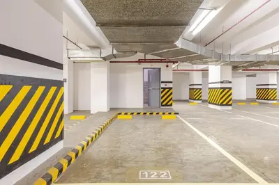 an empty parking garage with yellow and black stripes at Perfect accommodation for you in Levels Burbank in Manila