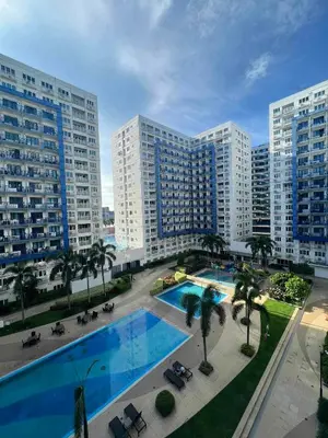 an overhead view of a large swimming pool with buildings at Oasis MOA- Sea Residences in Manila