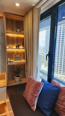 a living room with a window with a view of a city at Air Residence Makati Suite Sophisticated Living Condo 300 Mbps in Manila