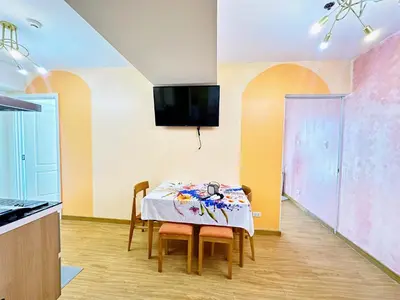 a kitchen and dining room with a table and chairs at 2 Bedroom Summer Themed Unit at Azure in Manila
