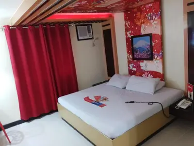 a bedroom with a bed with a red curtain at Hotel Sogo - EDSA, Pasay Harrison in Manila