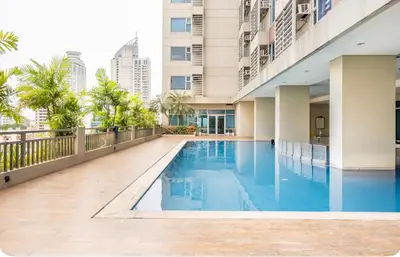 a swimming pool in the middle of a building at 8 Adriatico Homestay - S in Manila
