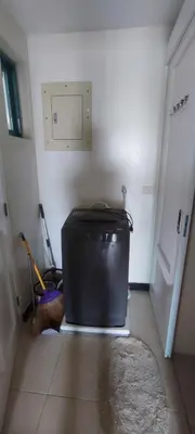 a room with a suitcase sitting on the floor next to a door at Tivoli Garden Residences, 1 Bedroom unit with sunset view in Manila