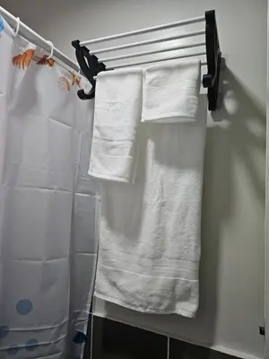a group of towels hanging on a towel rack in a bathroom at 5F J Phase1 Sevilla in Manila