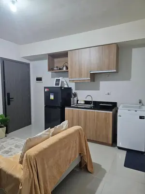 a kitchen with a black refrigerator and a stove at 5F J Phase1 Sevilla in Manila