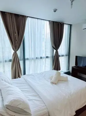 a bedroom with a white bed with windows at Luxury Place to stay in BGC in Manila